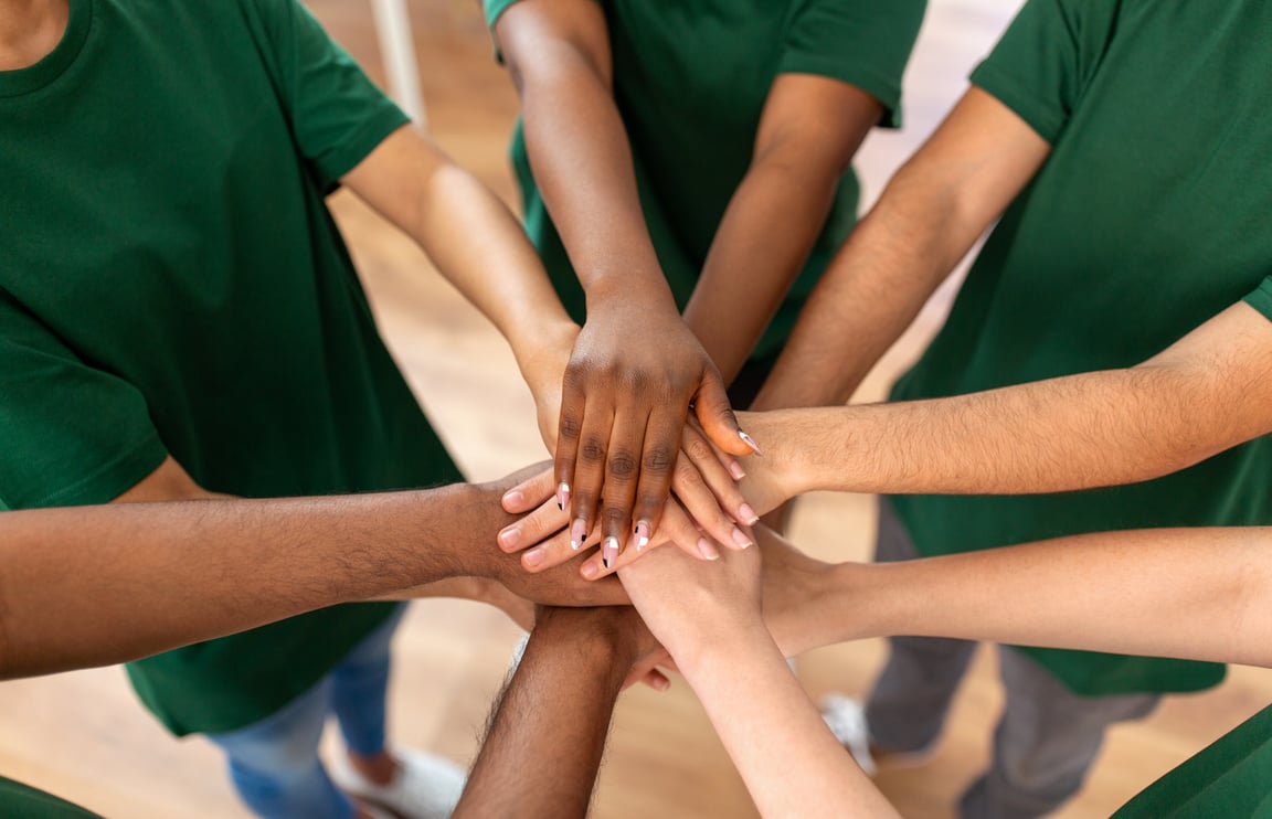 Close up of Volunteers Stacking Hands